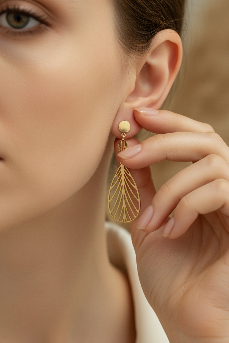 Close-up of a woman wearing gold earrings with a blurred background