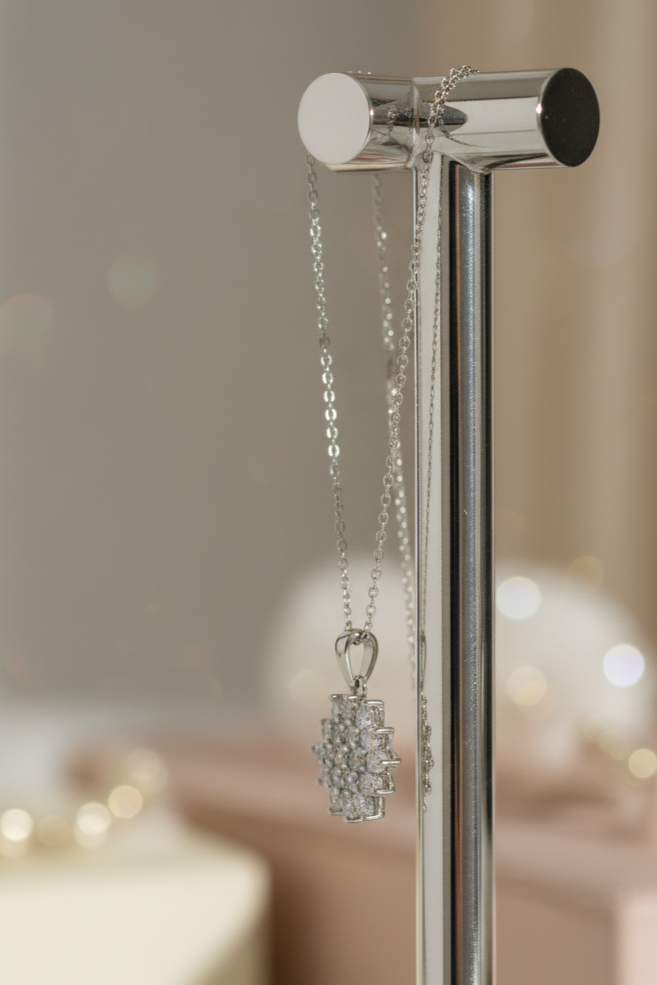 Silver necklace on a stand with a blurred background